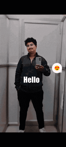 a man taking a selfie in front of a mirror with the words hello on his chest