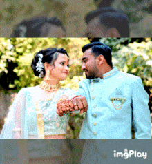 a bride and groom are posing for a picture and the bride is wearing a ring