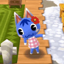 a blue cat with a red flower in its hair is standing on a wooden walkway