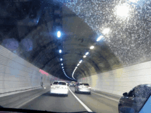 a car is driving down a highway in a tunnel with a license plate that says lg