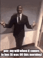 a man in a suit and tie is standing in a room with his arms outstretched and a caption .