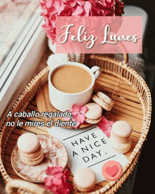 a cup of coffee sits on a wicker tray next to macarons