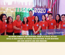 a group of people standing in front of a sign that says ' between stimulus and response there is a space ' on it