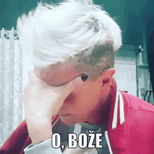 a man with white hair is covering his face with his hand and the word o boze is above him