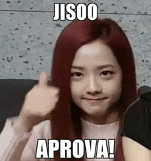 a girl with red hair is giving a thumbs up and a meme .