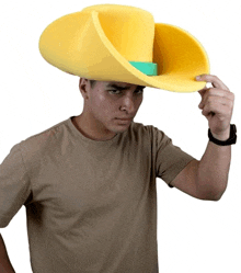 a man wearing a yellow cowboy hat with a green stripe