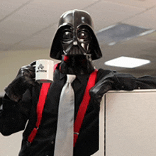 a man in a darth vader costume holds a cup of coffee