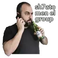 a man talking on a cell phone while holding a bottle of mazza