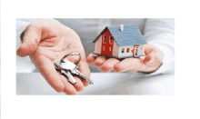 a person is holding a house and keys in their hands .