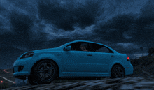 a blue car is driving down a road with a cloudy sky in the background