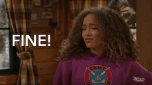 a girl with curly hair is wearing a purple shirt that says camp on it