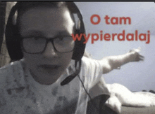 a man wearing glasses and headphones with the words " o tam wypierdalaj " above him