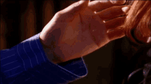 a close up of a person 's hand touching another person 's hand .