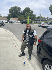 a man with a green mohawk is standing on the side of the road