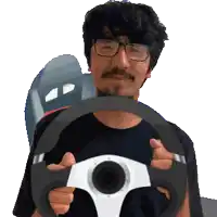 a man with glasses is holding a steering wheel in his hands