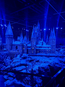 a model of hogwarts castle is lit up in blue