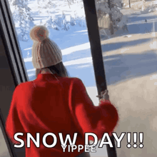 a woman in a red sweater and hat is looking out a window with the words snow day !!! written below her