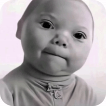 a black and white photo of a baby wearing a turtleneck