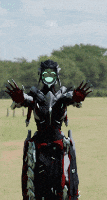 a robot with a green face is standing in a field with trees in the background