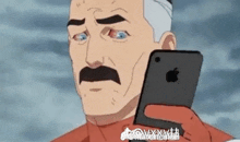 a man with a mustache is holding an apple iphone in his hand .