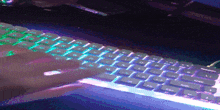 a person is typing on a keyboard with a green light behind the shift key