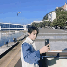 a man taking a picture of a body of water