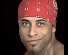 a man wearing a red bandana with letters o and b on it