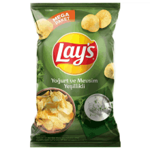 a bag of lays chips with a bowl of chips