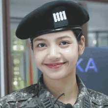 a close up of a woman in a military uniform wearing a beret and smiling .