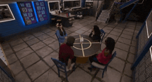 a group of people are sitting around a table with a target in the middle