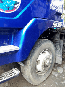 a blue truck with a for hire sticker on it