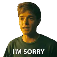 a young man says i 'm sorry in a green shirt