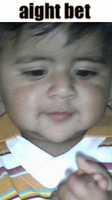 a close up of a baby 's face with the words ` ` aight bet ' ' written above it .