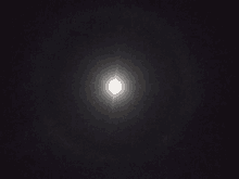 a full moon shines brightly in the dark night sky