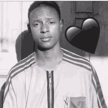 a black and white photo of a young man with a heart on the background