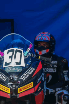 a motorcycle racer with the number 30 on the front of his bike