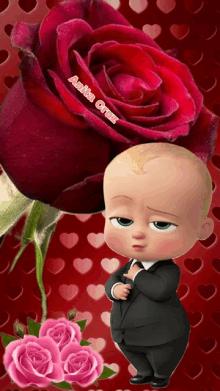 a baby in a suit is standing next to a large red rose