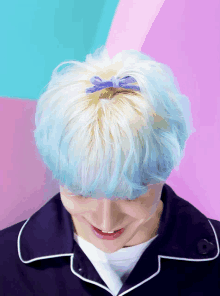 a person with blue hair and a blue bow in it