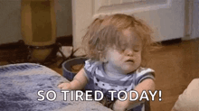 a little girl is sitting on a couch with her eyes closed and says `` so tired today ! ''