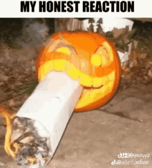 a pumpkin carved to look like a cigarette with a face on it