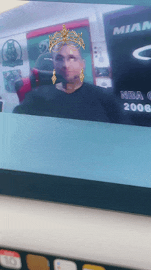 a computer screen shows a man wearing a crown and earrings