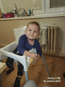 a baby is sitting in a high chair with the date of october 6th 2024 on the bottom