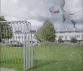 a person is flying a kite over a soccer goal in a field