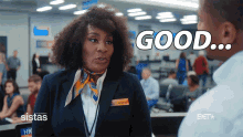 a woman in a stewardess uniform says " good " to a man