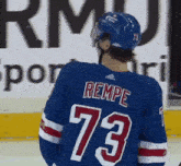 a hockey player wearing a jersey with the number 73 on it