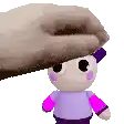 a hand is petting a stuffed animal with a purple shirt and pink sleeves .