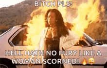 a woman is standing in front of a car that is on fire and says `` hell hath no fury like a woman scorned ''