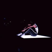 a man sits on a platform with a lot of lights behind him