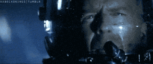 a close up of a man 's face in a dark room with the words xxbeckonings tumblr on the bottom
