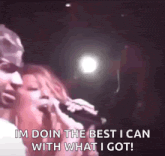 a man and a woman singing into microphones and the man says im doin the best i can with what i got